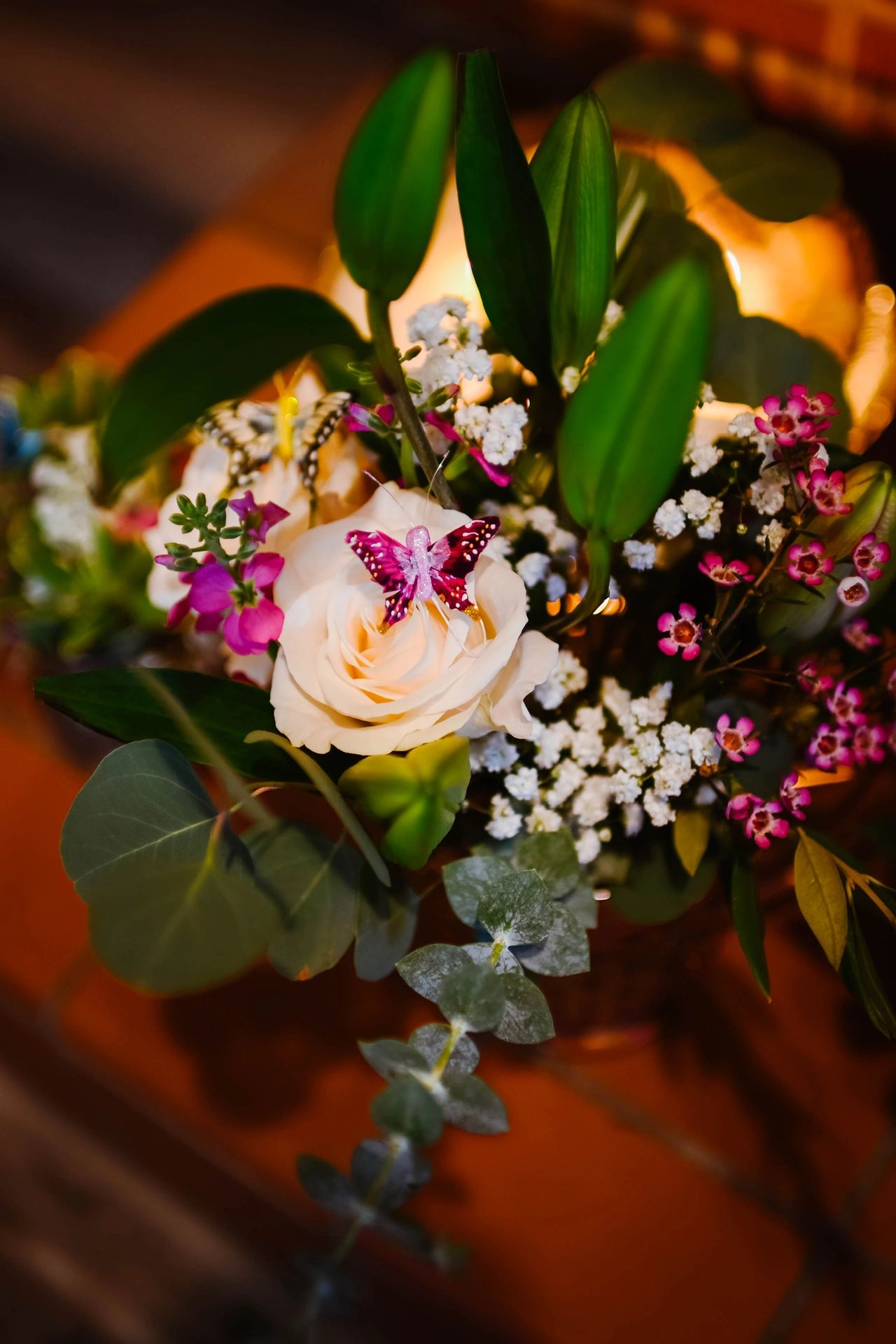 Inexpensive flowers from Trader Joe's look elegant in vintage pitchers and adorned with tiny butterflies.