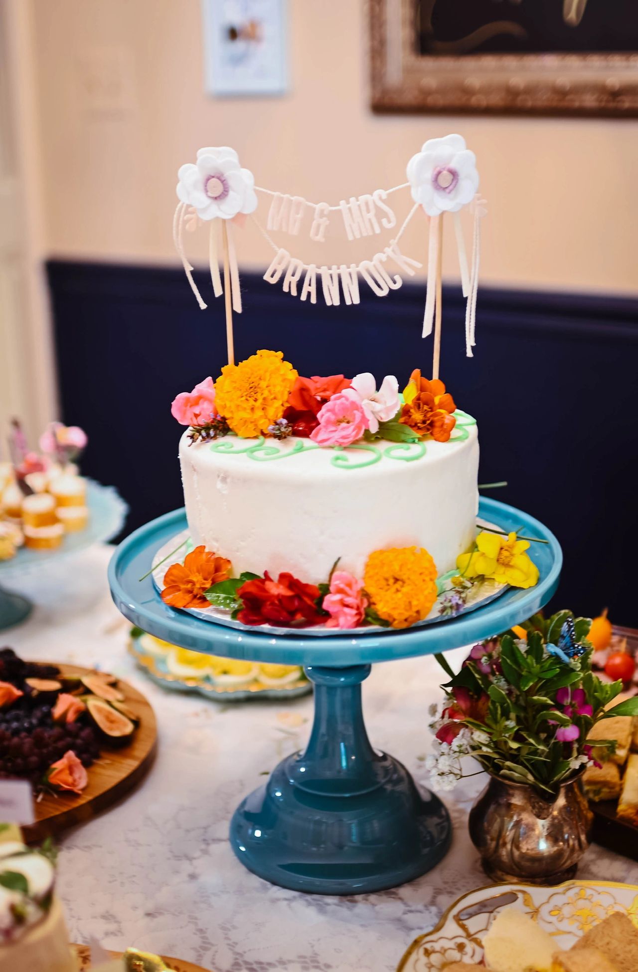 Blue glass cake stand with cake on top.