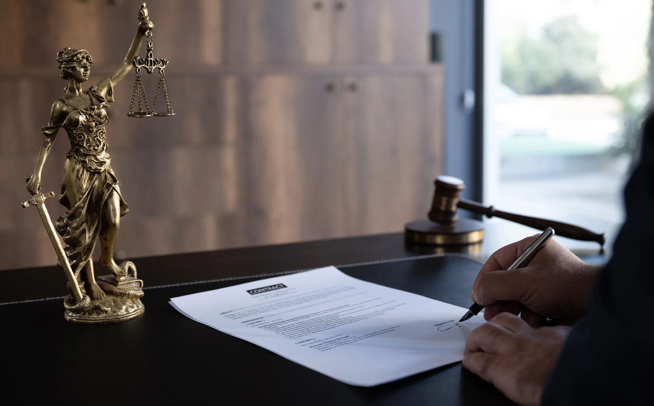 Judge or Legal advisor lawyer examining and signing legal documents.