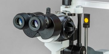 Close-up of a professional binocular microscope used for medical examinations.