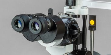 Close-up of a professional binocular microscope used for medical examinations.