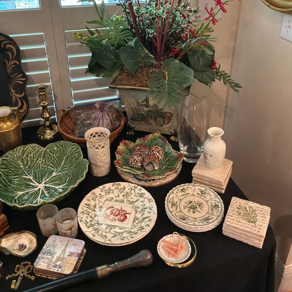 Collection of decorative plates and vases on a table.