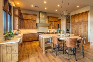 Spacious wooden kitchen with island and dining area.
