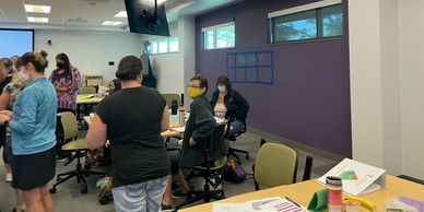 People collaborating in a modern office or classroom setting.