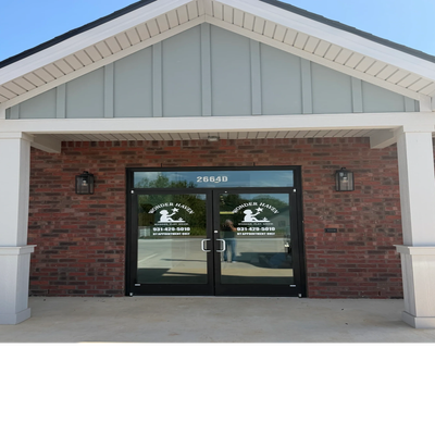 Entrance of Powder Haist with brick walls and glass doors.
