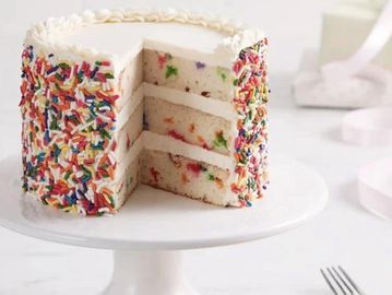 A melt in your mouth vanilla cake with colorful sprinkles, buttercream, and sweetness in every bite