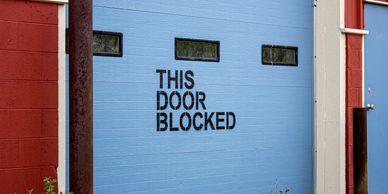 A concerning image of a blocked exit in a building, highlighting potential safety hazards.
