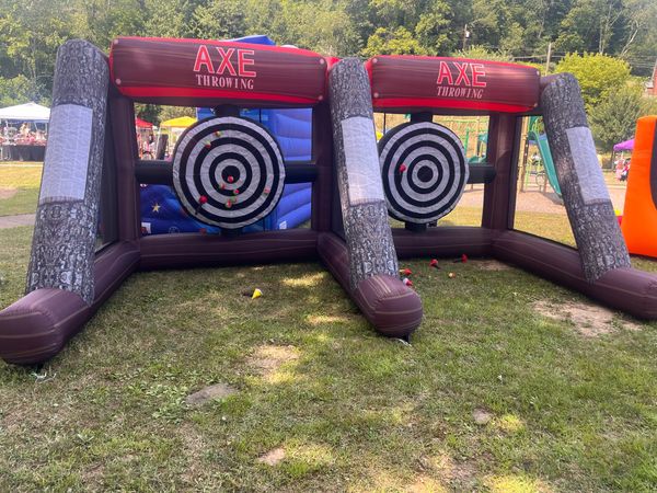 Inflatable axe throw at a backyard birthday party