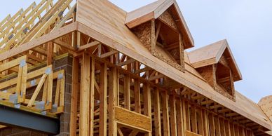 new home under construction framed with two cape cod style gables on the front 