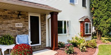 brick house white vinyl siding cedar posts