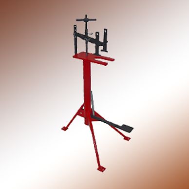 Red and black metal bike stand with adjustable clamps and foot pedal.