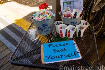 table with saltwater taffy and clipboard with please eat yourself sign 2