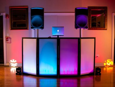 Sinatra singer Dottoli performing alongside DJ setup on dance floor for wedding or corporate party