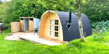 cute glamping holiday pod with private toilet, shower and log burner