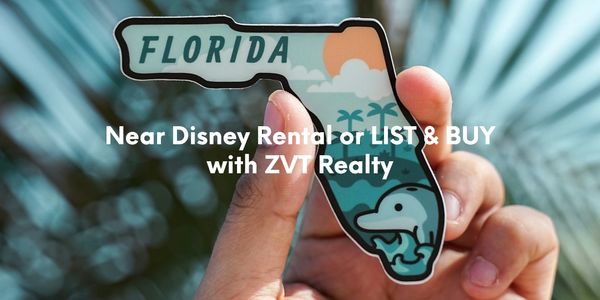 A hand holding up a florida shaped magnet.