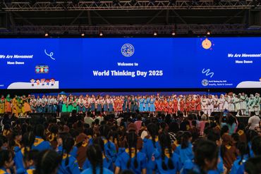 Large group of Girl Guides on stage for World Thinking Day 2025 event.