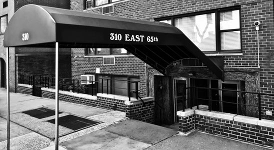 Entrance canopy at 310 East 65th street in black and white.