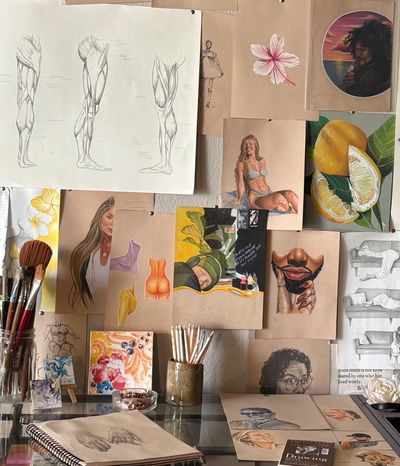 Close up shot of desk in art studio with materials and drawings
