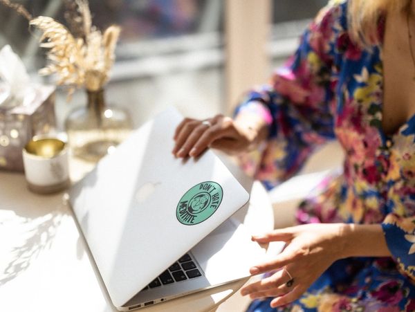 a coach and yoga teacher opening her laptop for a video conference 