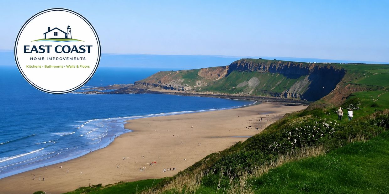 Scenic coastal beach with cliffs and people walking near the shore.