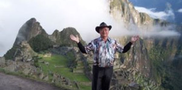 John standing in front of a mountain