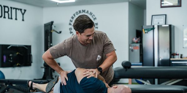 Dr. Brandon Antonissen using chiropractic techniques on a patient's back.