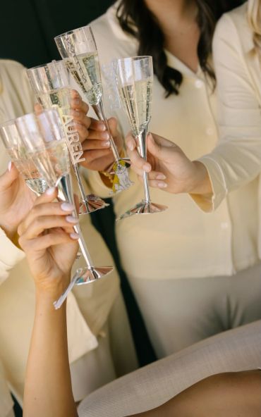 Group toasting with champagne glasses at a celebration.