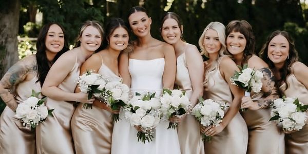 Bride with bridesmaids in matching champagne dresses.