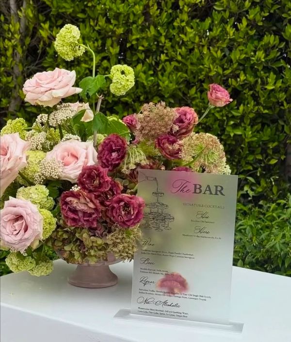 Elegant flower arrangement with a bar menu card.
