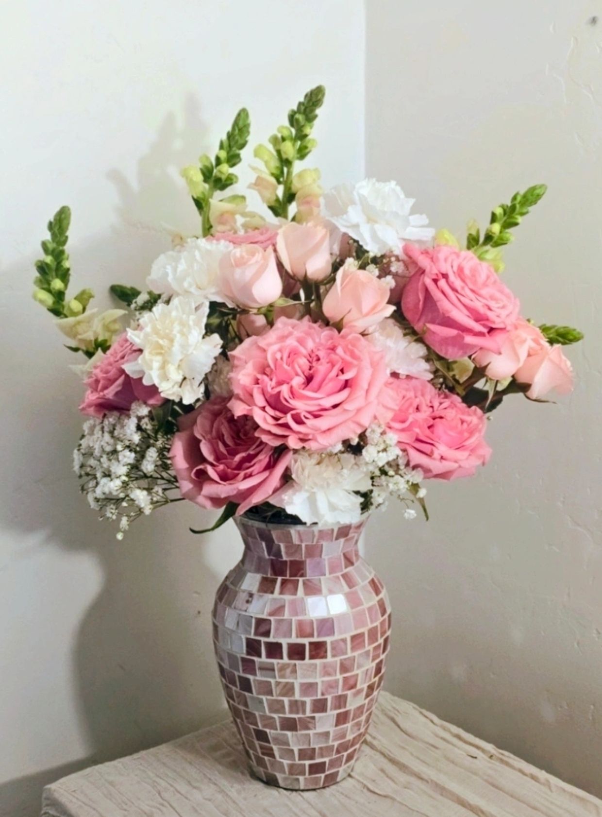 Beautiful pink and white flower bouquet in mosaic vase.