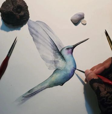 Realistic hummingbird watercolor painting in progress.