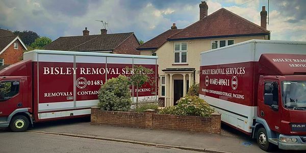 Bisley Removals vans unloading at a property