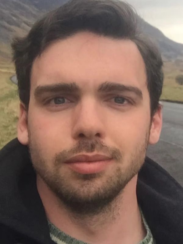 Close-up of a young man outdoors.