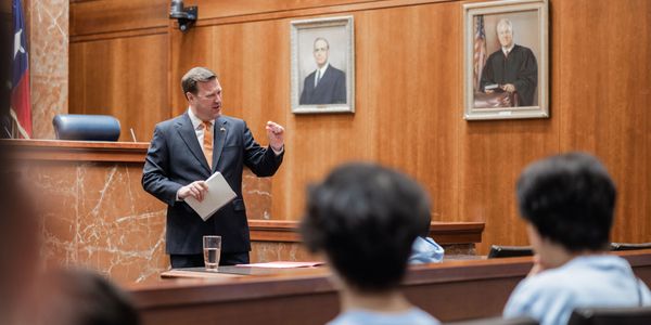Lawyer presenting a case in a courtroom to the jury.