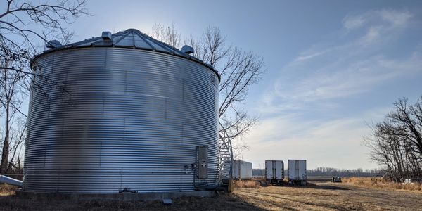 A colorful landscape featuring mountains, trees, and a clear blue sky.