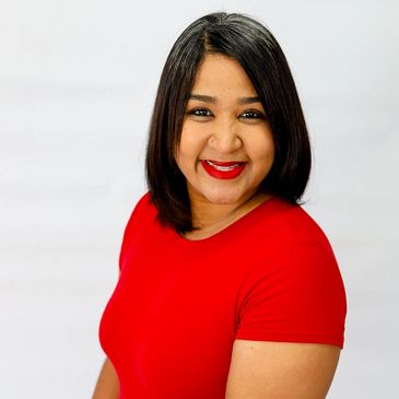 Woman smiling in red shirt with straight black hair.