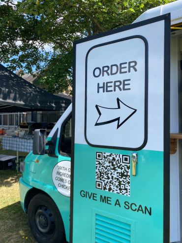 Food truck with an 'Order Here' sign and QR code.