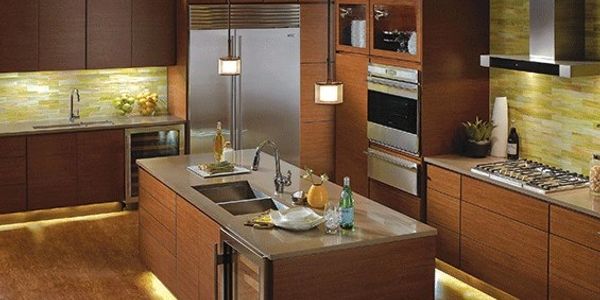 Kitchen remodel with pendants over the island and under cabinet lights and toe kick lighting for ambiance.