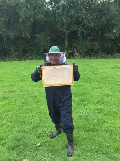 George McGee with a frame of honey from a hive given Mineral Bee.