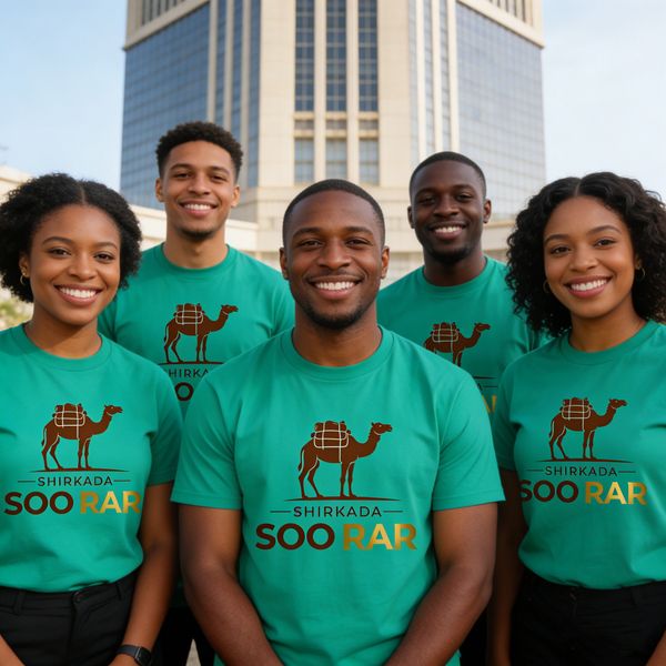 Five smiling young adults wearing matching teal shirts with a camel logo and "Shirkada Soo Rar" text.