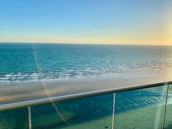 Peaceful ocean view from a balcony at sunrise or sunset.
