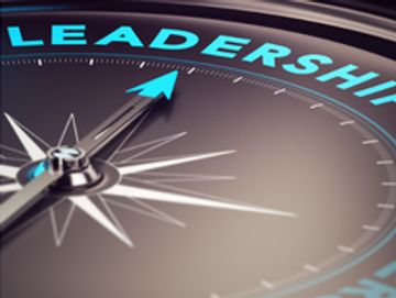 compass with arrow pointing to word leadership in blue font