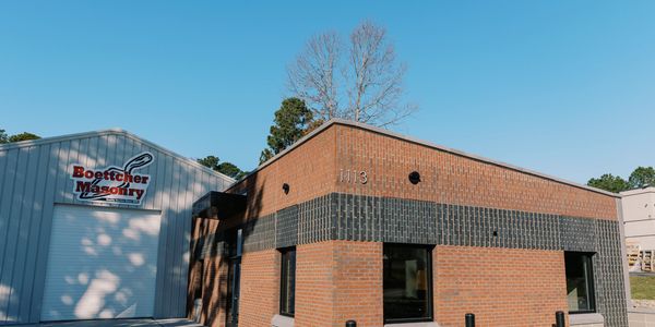 Brick and metal commercial building under clear blue sky.