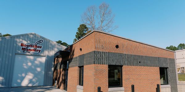 Brick and metal commercial building under clear blue sky.