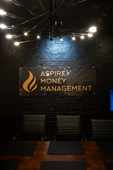 Office meeting room with a sign for Aspire Money Management.