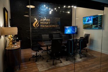 Modern conference room with "Aspire Money Management" signage.