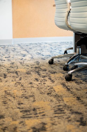 Office chairs on patterned carpet floor.