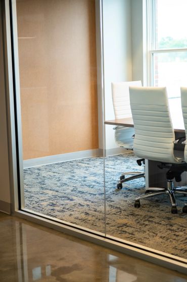 Modern office conference room with white chairs.