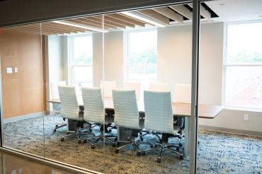 Modern empty conference room with white chairs.