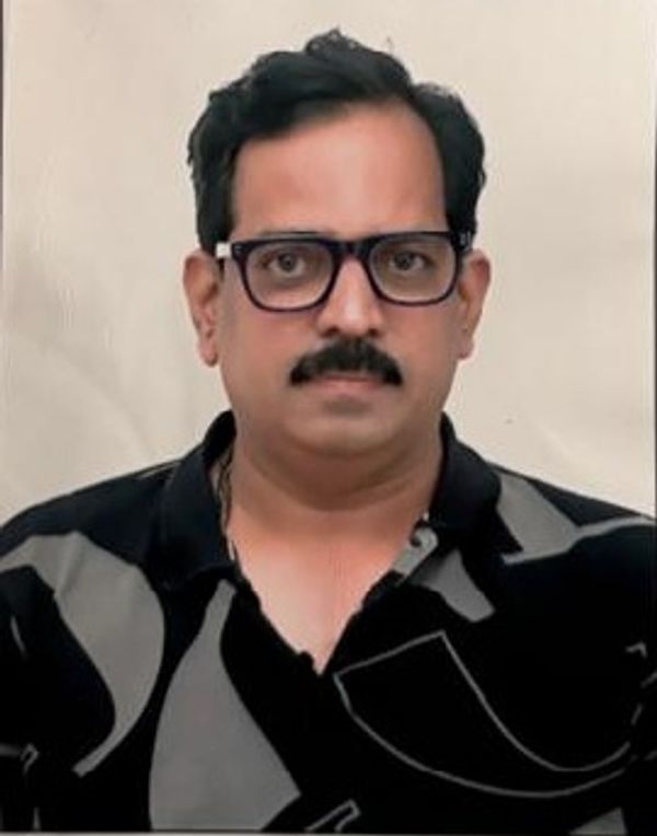 Man with glasses and mustache in a black shirt.